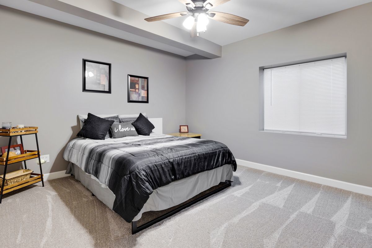 3001 Wagon Road Elgin, IL 60124 - Photo 28 of 39 a bedroom with a bed and a lamp on dresser