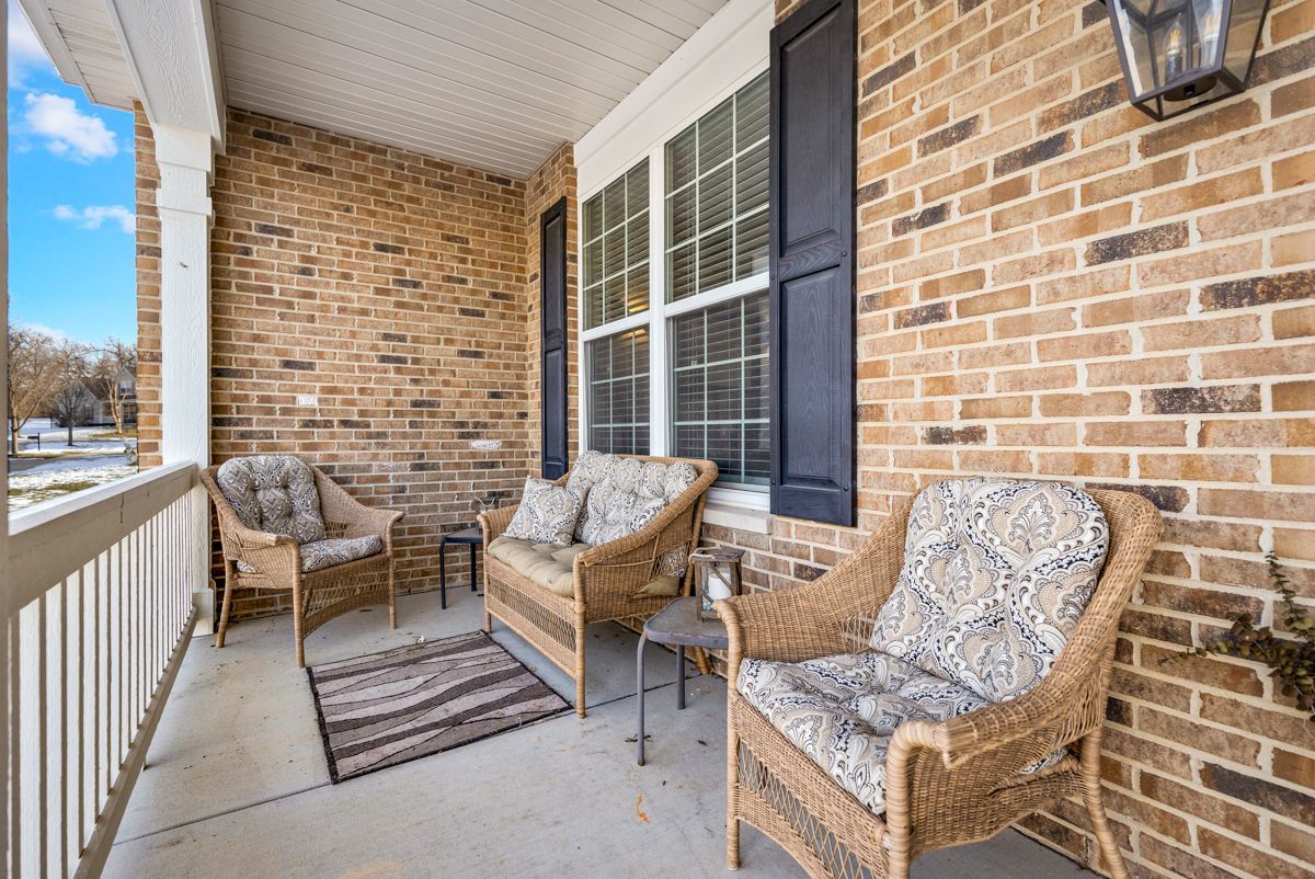3001 Wagon Road Elgin, IL 60124 - Photo 4 of 39 a balcony with couple of chairs and a wooden floor