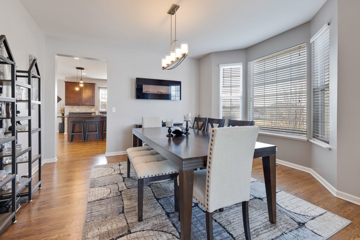 3001 Wagon Road Elgin, IL 60124 - Photo 8 of 39 a view of a dining room with furniture window and wooden floor