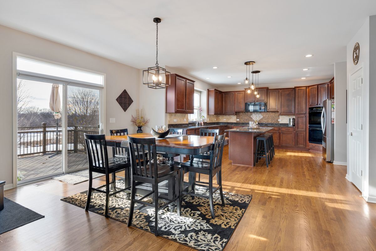 3001 Wagon Road Elgin, IL 60124 - Photo 10 of 39 a view of a dining room and livingroom with furniture wooden floor a chandelier