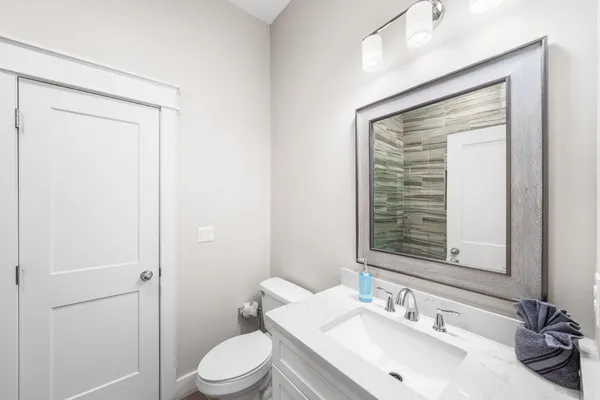 a view of washer and dryer with bathroom in the background