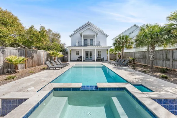 a view of a house with a yard patio and swimming pool