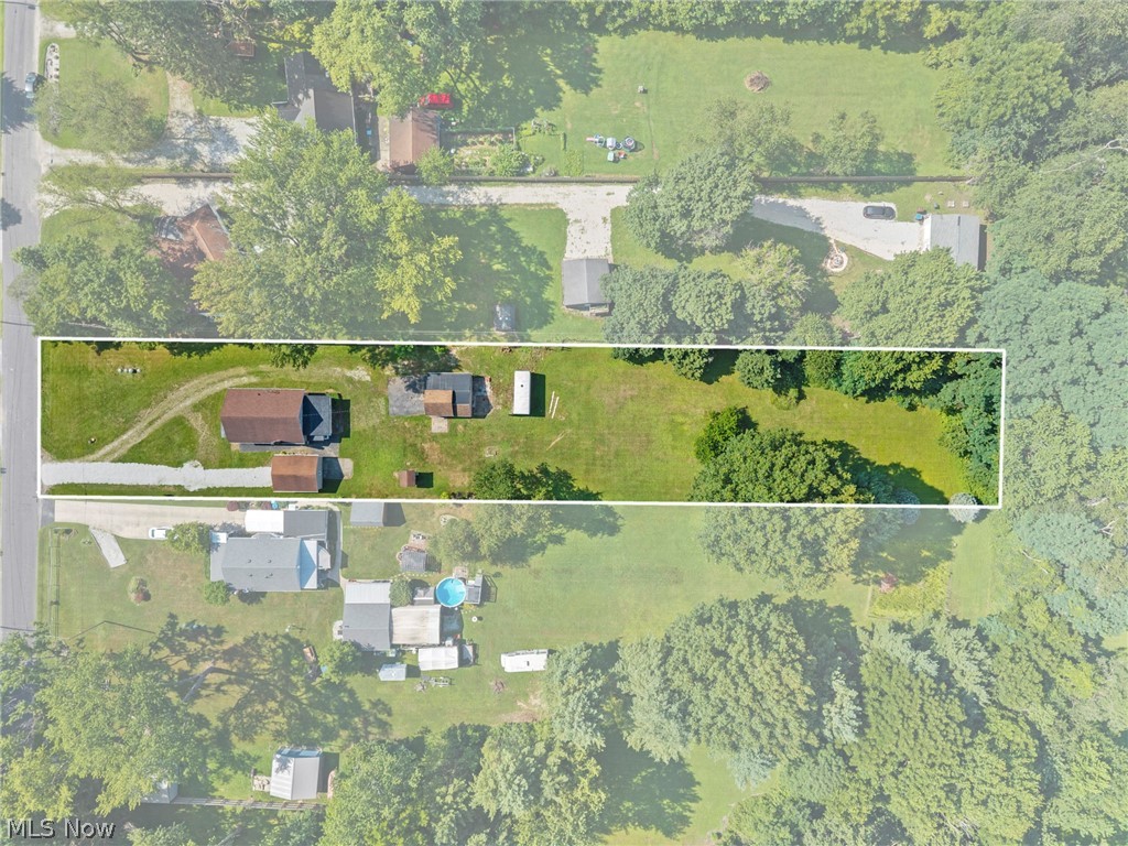 1218 Briggle Road Akron, OH 44320 - Photo 33 of 40 Aerial property overview featuring an expansive lot with a main residence, two accessory structures, a gravel driveway, and mature trees