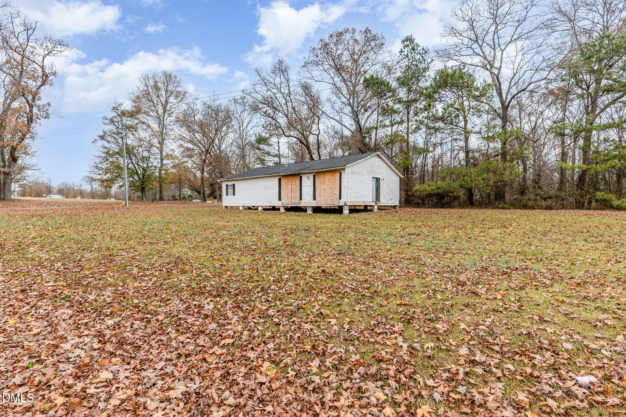 6801 Rock Service Station Road Raleigh, NC 27603 - Photo 32 of 36 a view of a house with a yard and covered with trees