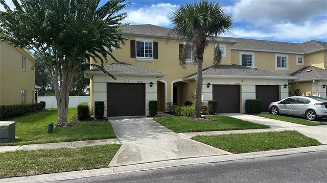 a front view of a house with a yard and garage