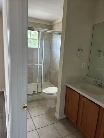 a bathroom with a toilet a sink and shower