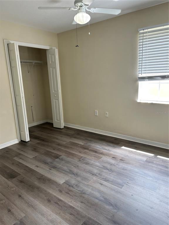 20474 Needletree Drive, Unit 20474 Tampa, FL 33647 - Photo 12 of 25 an empty room with wooden floor and windows