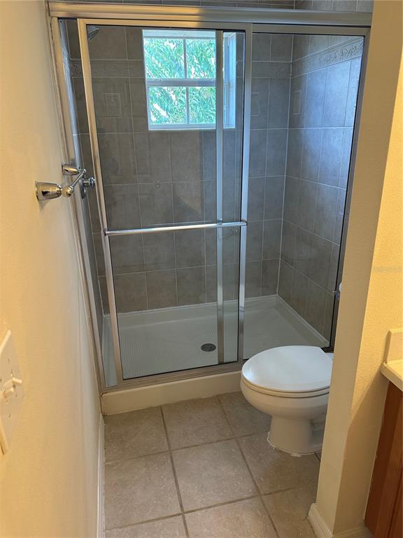 20474 Needletree Drive, Unit 20474 Tampa, FL 33647 - Photo 17 of 25 a bathroom with a shower and a toilet