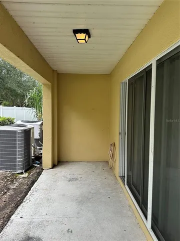 a view of an empty room with a fireplace and a window