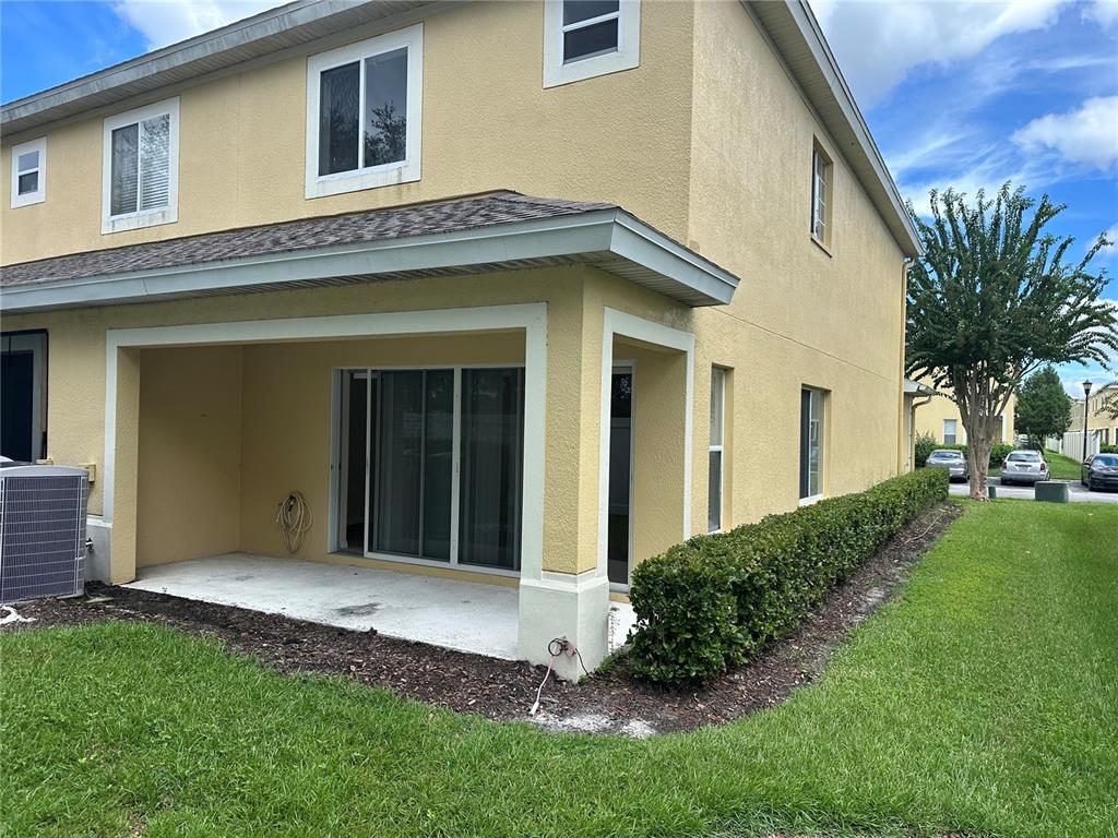 20474 Needletree Drive, Unit 20474 Tampa, FL 33647 - Photo 22 of 25 a view of a house with brick walls and a yard with plants
