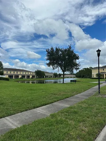 a view of a field of grass and trees