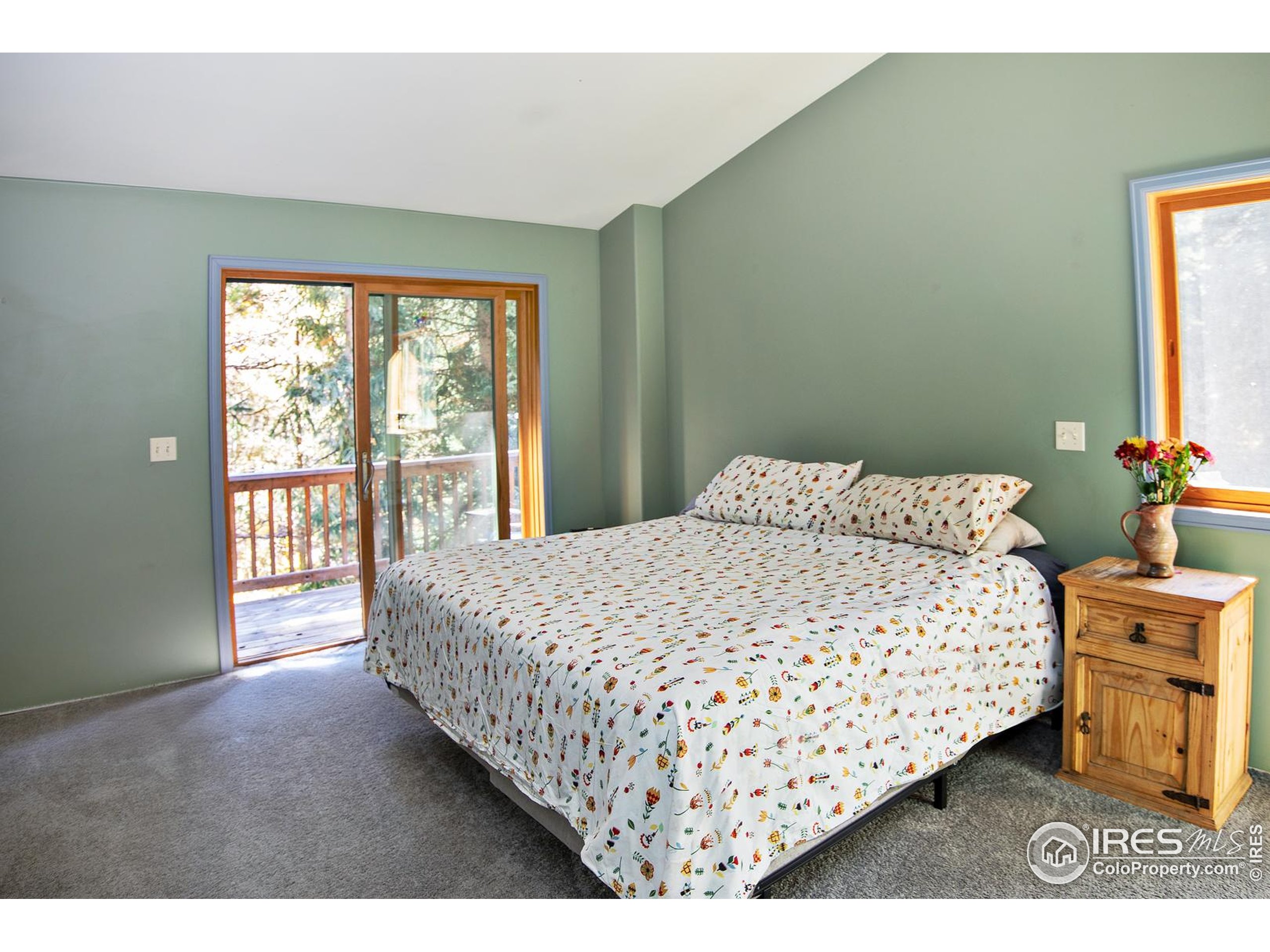 3727 Gamble Gulch Road Black Hawk, CO 80422 - Photo 20 of 30 a large bed sitting in a bedroom next to a window