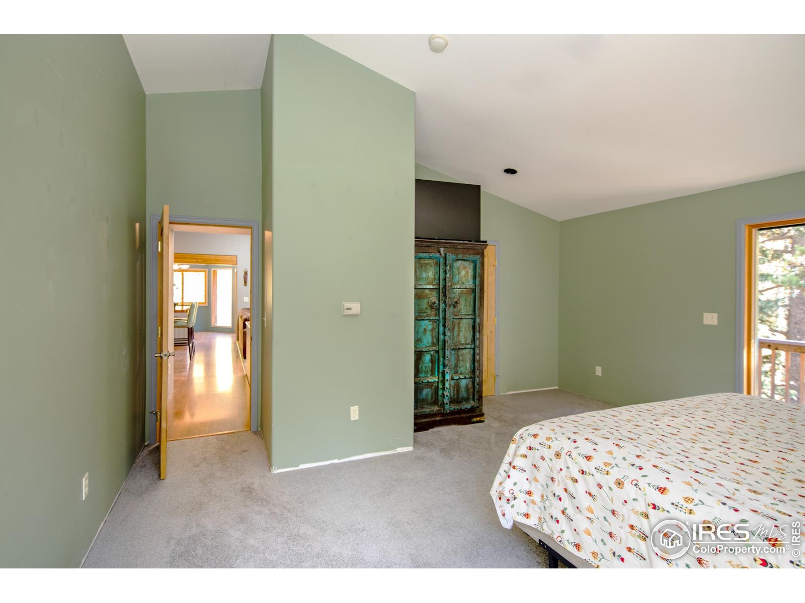 3727 Gamble Gulch Road Black Hawk, CO 80422 - Photo 21 of 30 a bedroom with a bed and a lamp