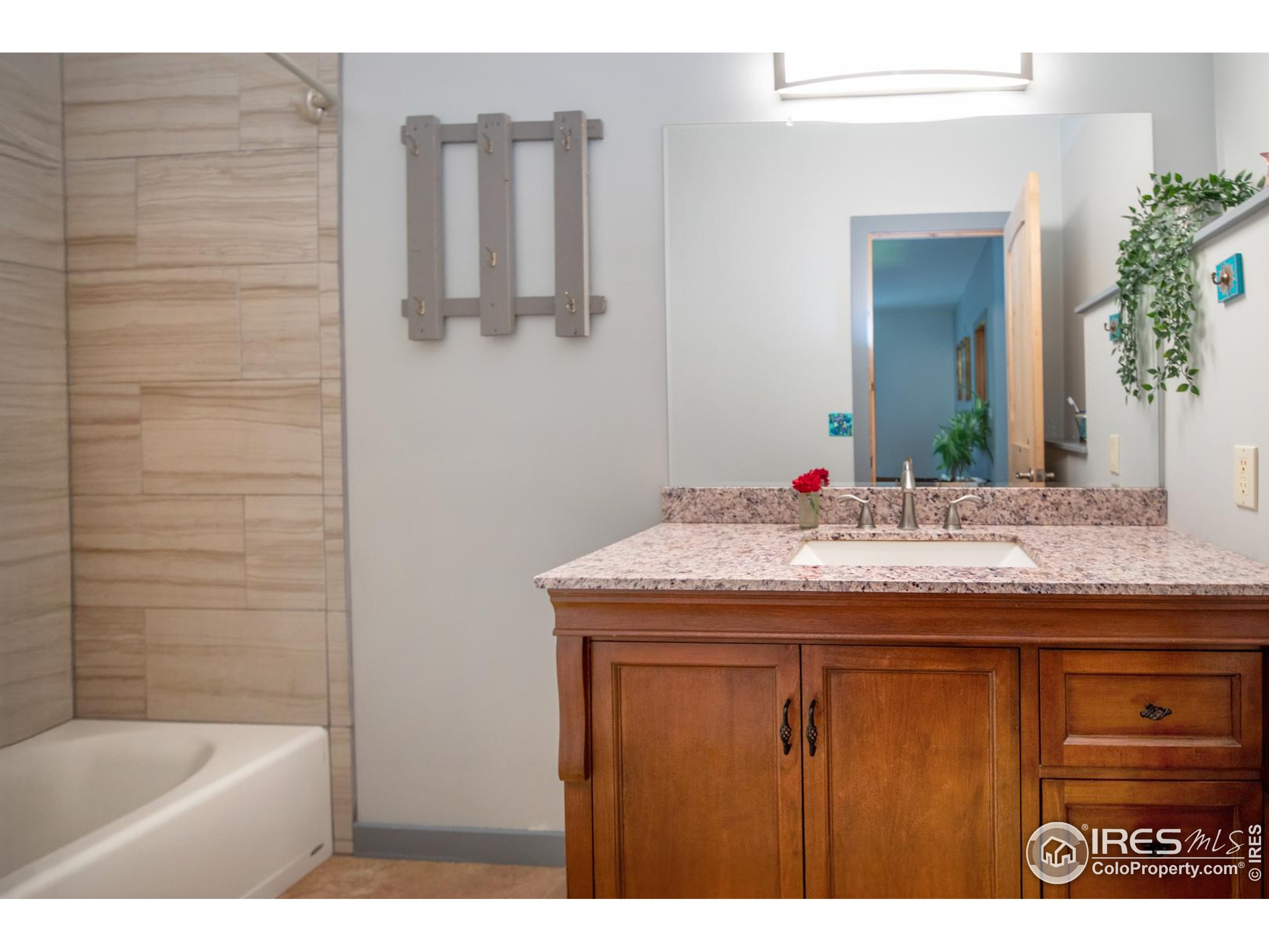 3727 Gamble Gulch Road Black Hawk, CO 80422 - Photo 29 of 30 a bathroom with a granite countertop sink and a mirror