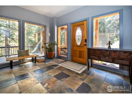 a kitchen with stainless steel appliances granite countertop a refrigerator a kitchen island a stove a table and chairs