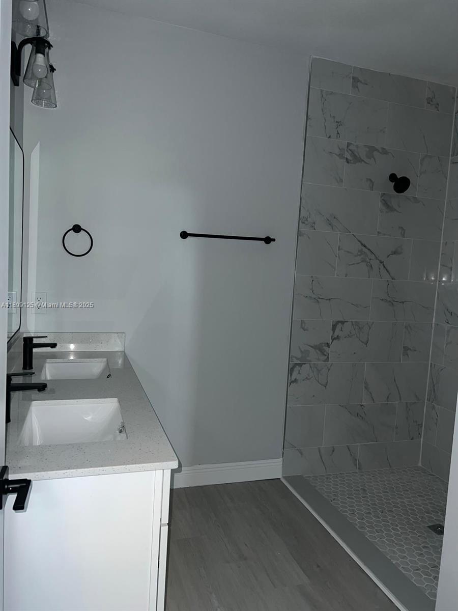 21068 Exmore Avenue, Unit 21068 Port Charlotte, FL 33952 - Photo 6 of 9 a bathroom with a sink a toilet and shower