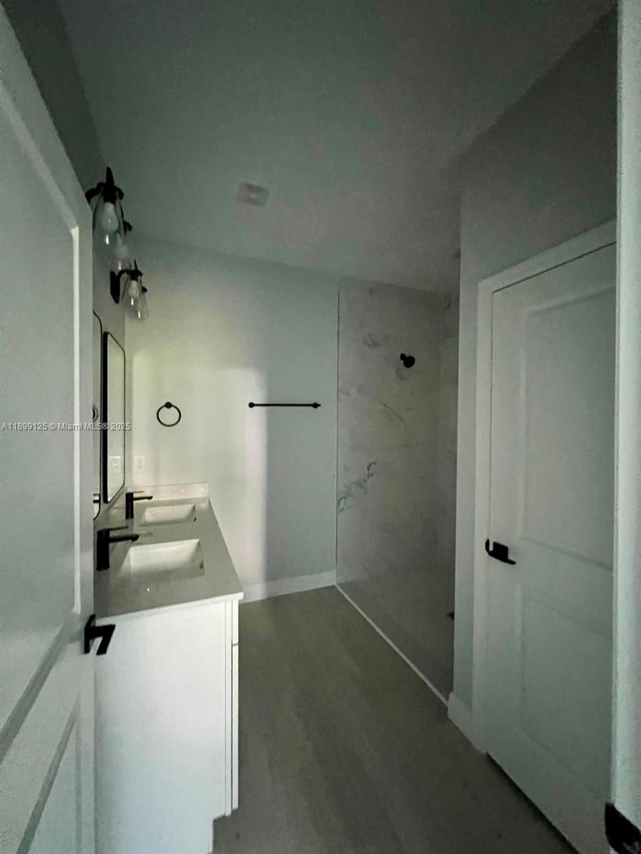 21068 Exmore Avenue, Unit 21068 Port Charlotte, FL 33952 - Photo 7 of 9 a bathroom with a sink and mirror