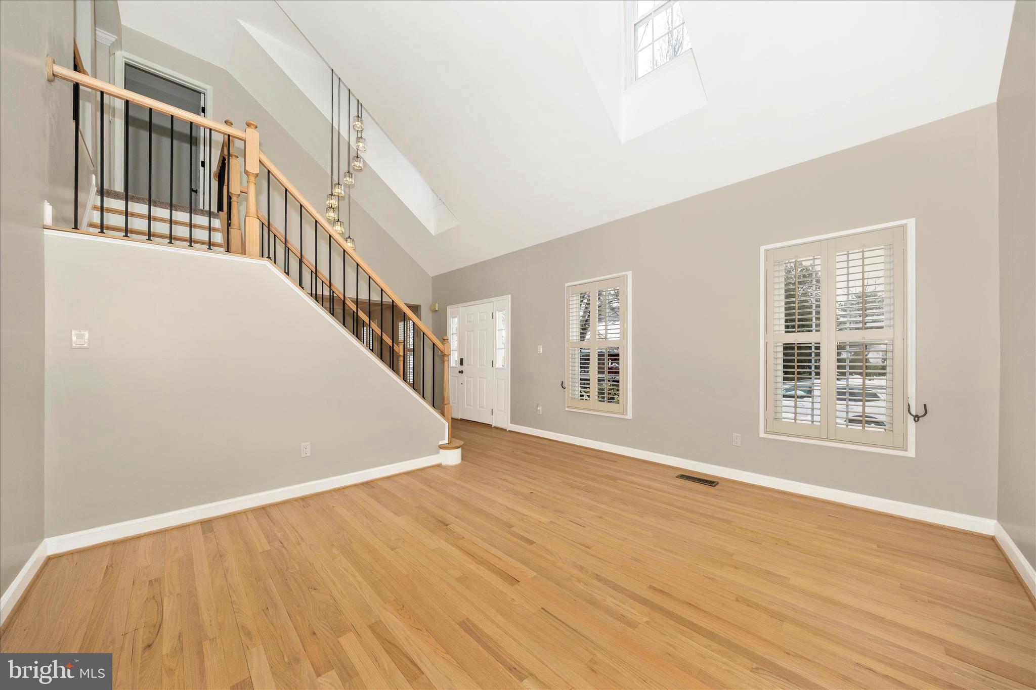 2478-5 Five Shillings Road Frederick, MD 21701 - Photo 12 of 77 a view of an empty room with wooden floor and a window
