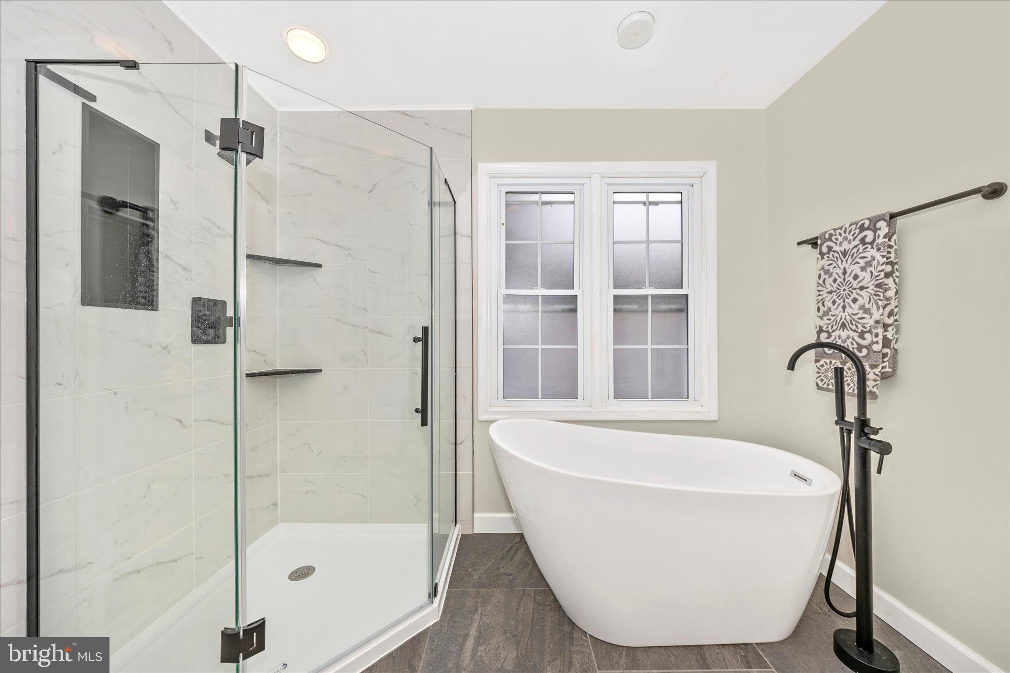 2478-5 Five Shillings Road Frederick, MD 21701 - Photo 34 of 77 a white bath tub sitting next to a shower