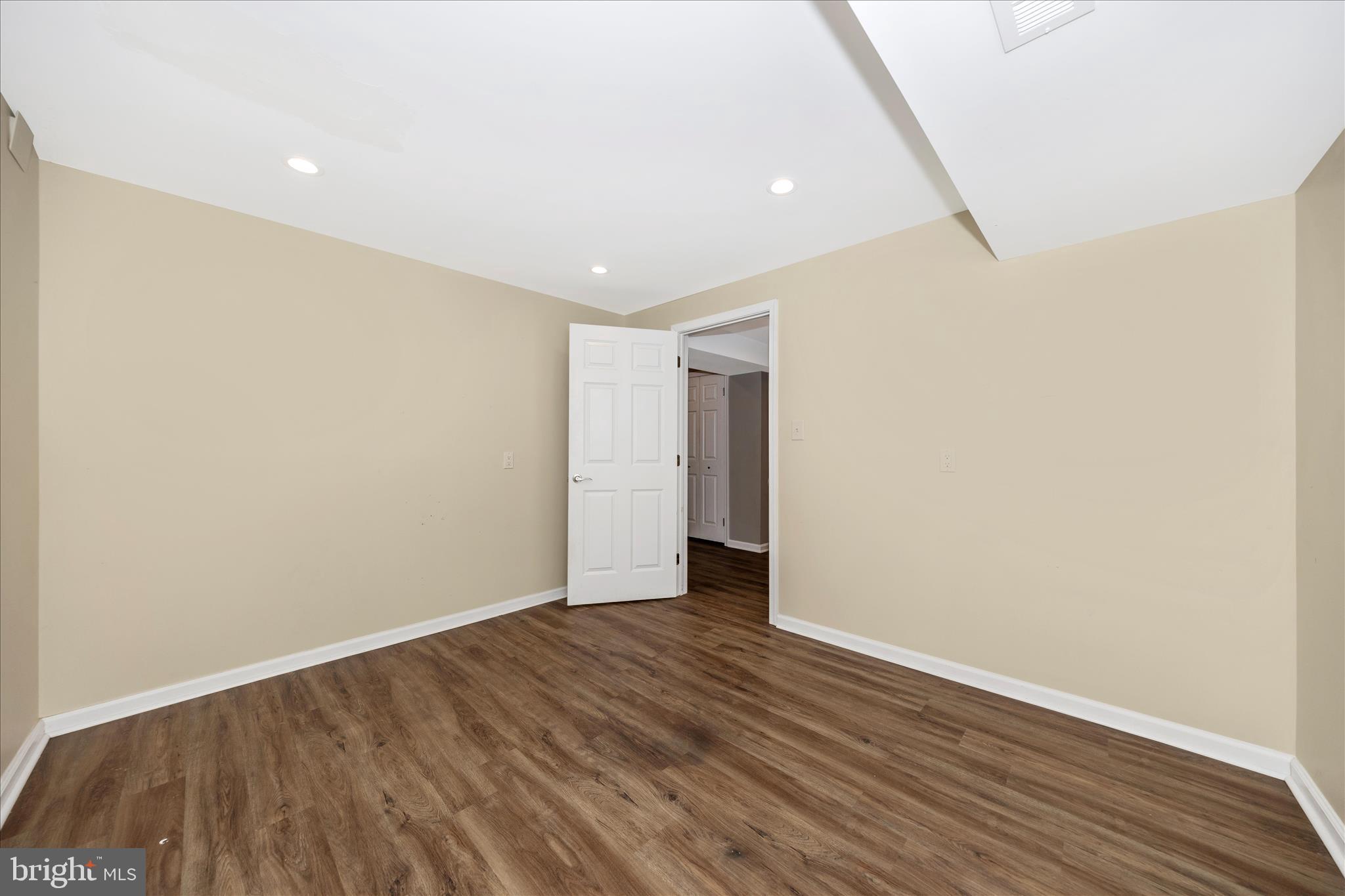 2478-5 Five Shillings Road Frederick, MD 21701 - Photo 54 of 77 a view of an empty room with wooden floor