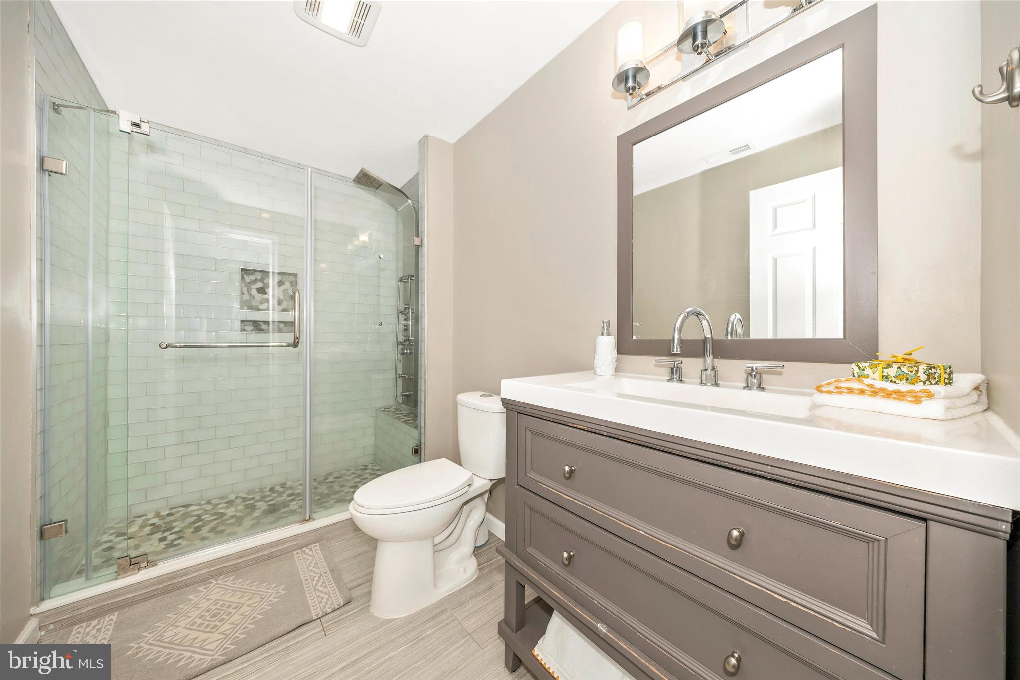 2478-5 Five Shillings Road Frederick, MD 21701 - Photo 55 of 77 a bathroom with a sink a toilet a mirror and shower