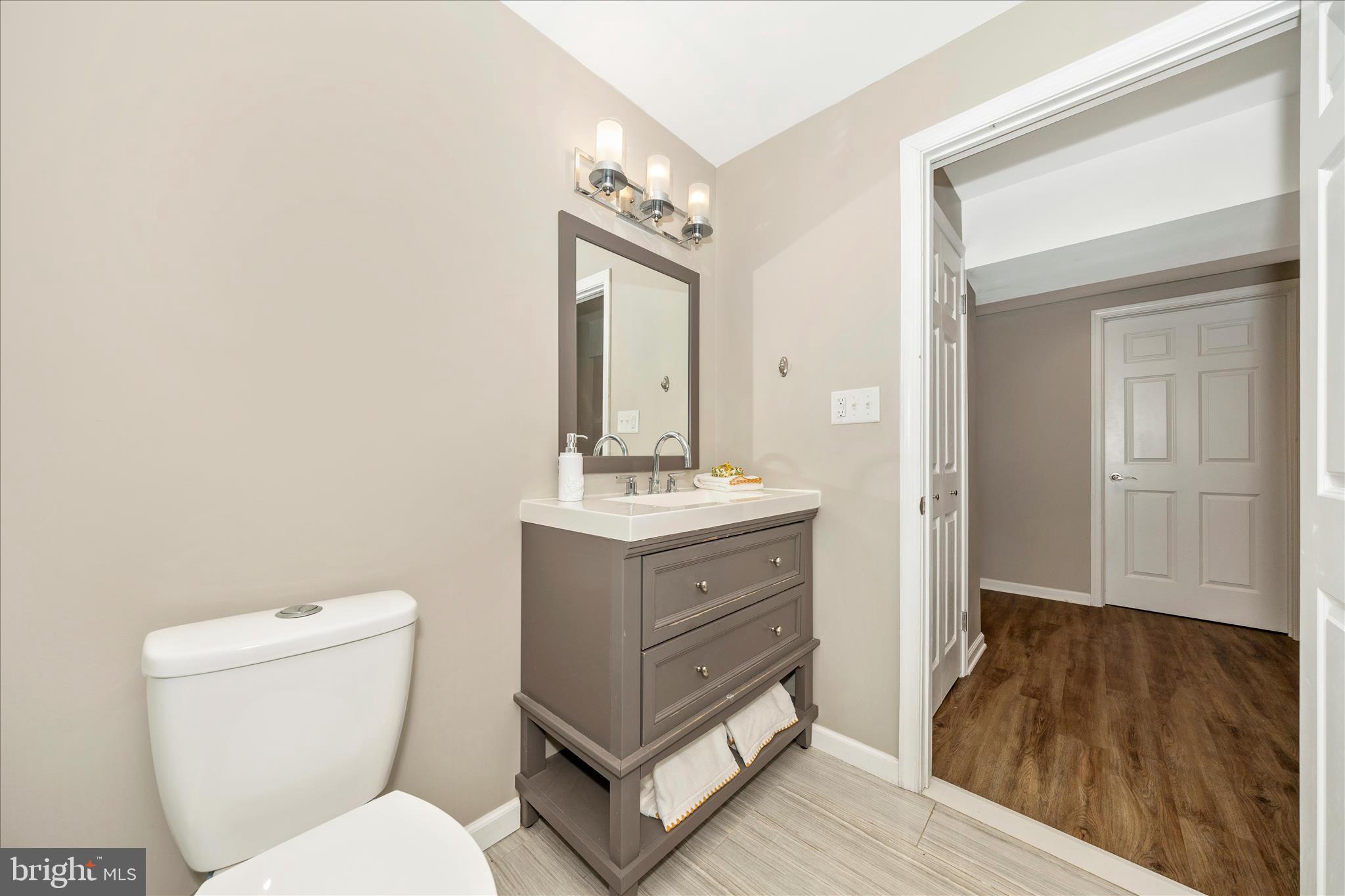 2478-5 Five Shillings Road Frederick, MD 21701 - Photo 56 of 77 a bathroom with a toilet sink and mirror