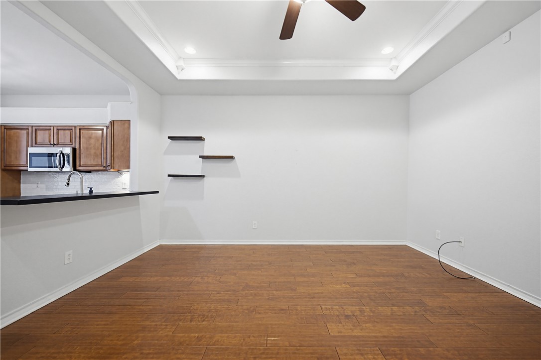 7251 Prairie Drive, Unit 6 Corpus Christi, TX 78413 - Photo 12 of 28 a view of kitchen and empty room with wooden floor