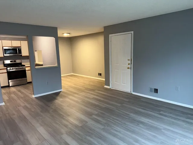 a view of a kitchen with wooden floor and a sink