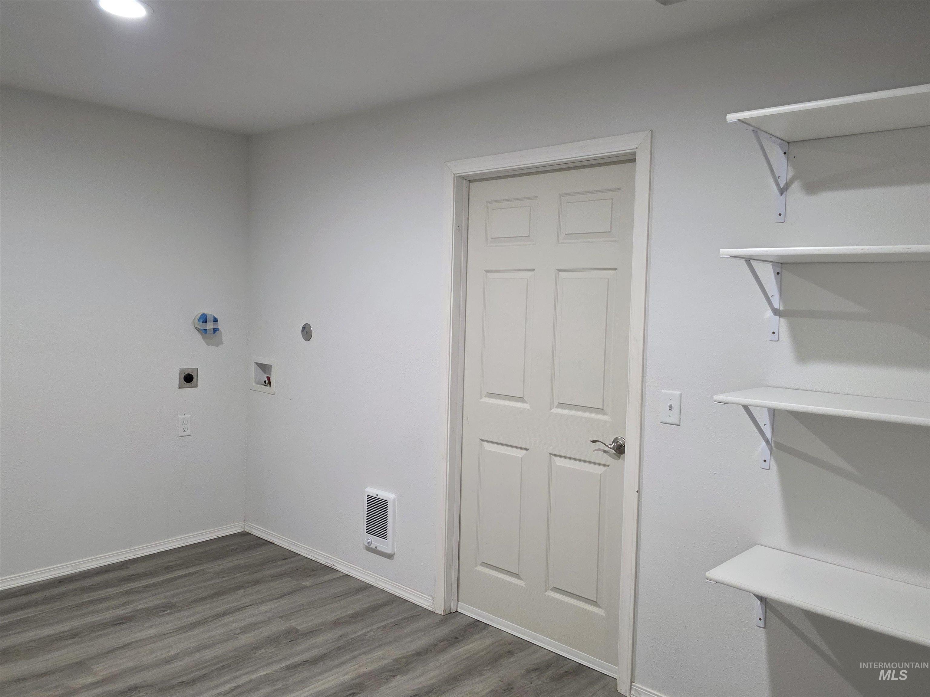 503 Oak Street Kamiah, ID 83536 - Photo 17 of 36 Laundry area with dark wood-style floors, hookup for a washing machine, and electric dryer hookup