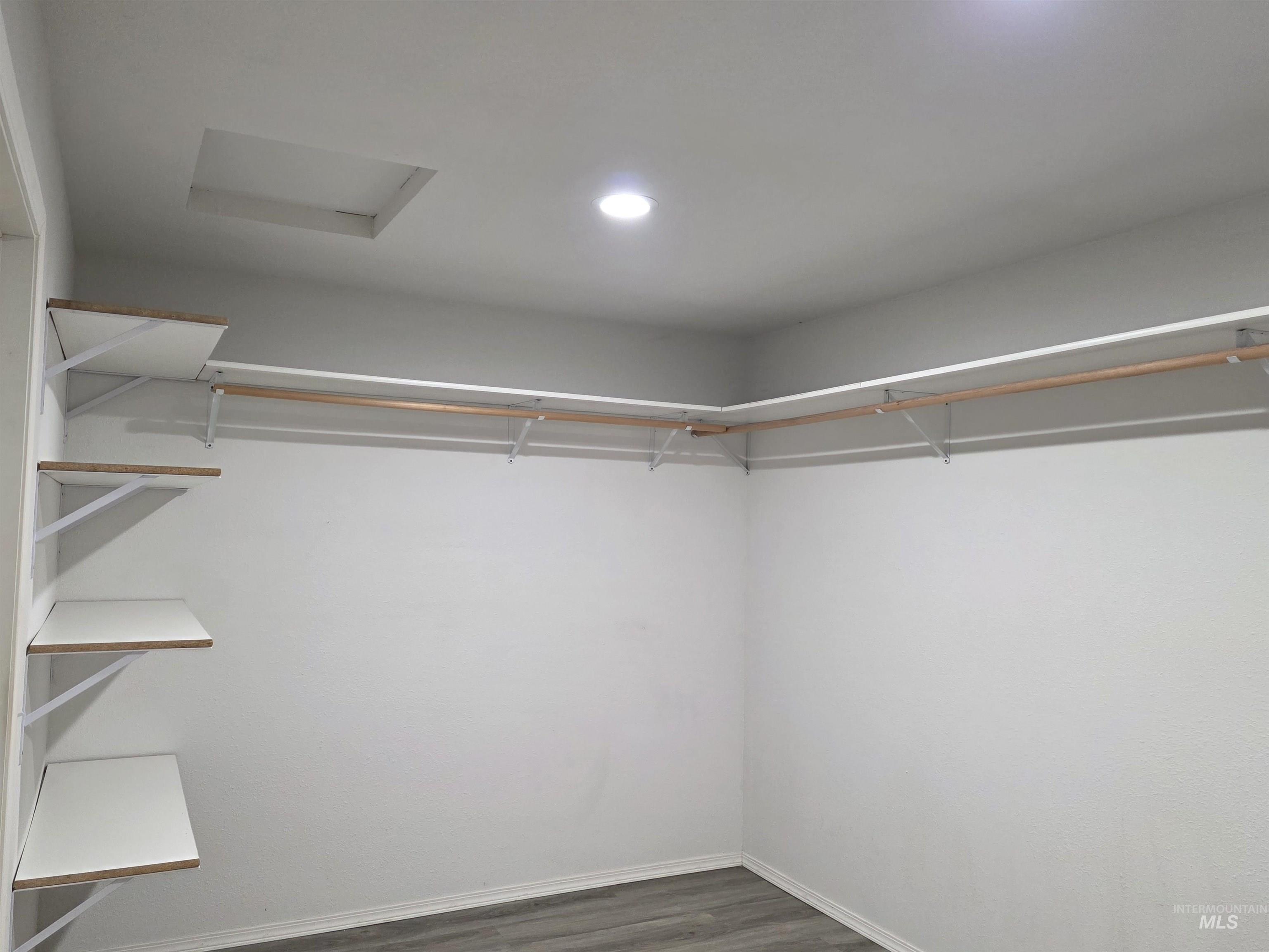 503 Oak Street Kamiah, ID 83536 - Photo 19 of 36 Walk in closet featuring attic access and dark wood-style floors