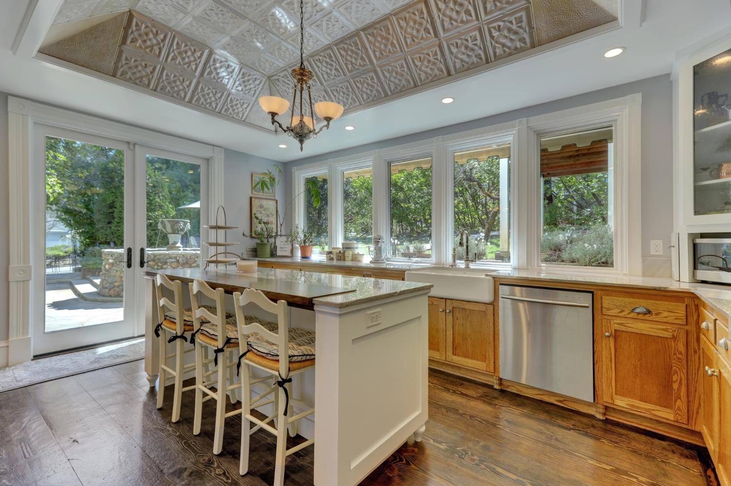 203 Prospect Street Nevada City, CA 95959 - Photo 14 of 95 Modern gourmet kitchen with tin coffered ceiling, surrounding windows and quartz counters