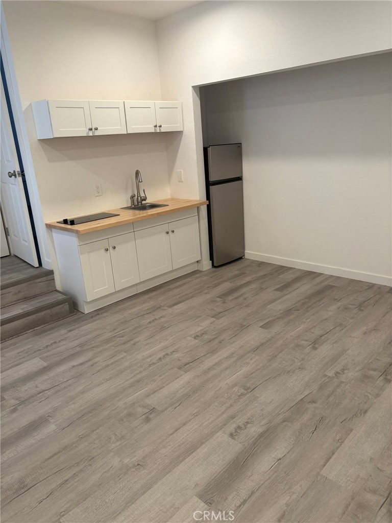 1362 South Downey Road Los Angeles, CA 90023 - Photo 28 of 30 a kitchen with a refrigerator sink and cabinets