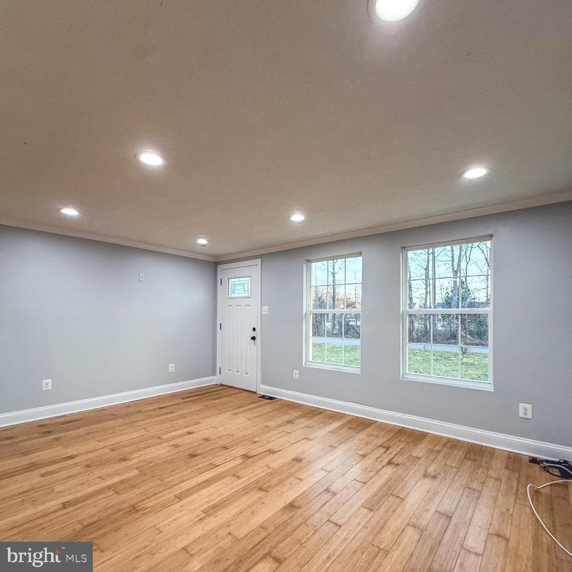 205 Biddle Road Accokeek, MD 20607 - Photo 14 of 31 an empty room with wooden floor and windows