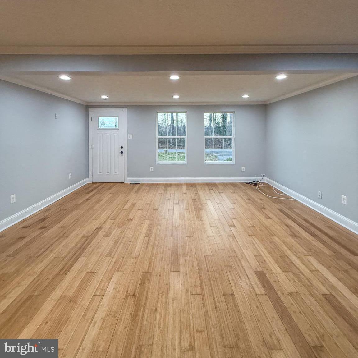 205 Biddle Road Accokeek, MD 20607 - Photo 15 of 31 a view of an empty room with wooden floor and windows