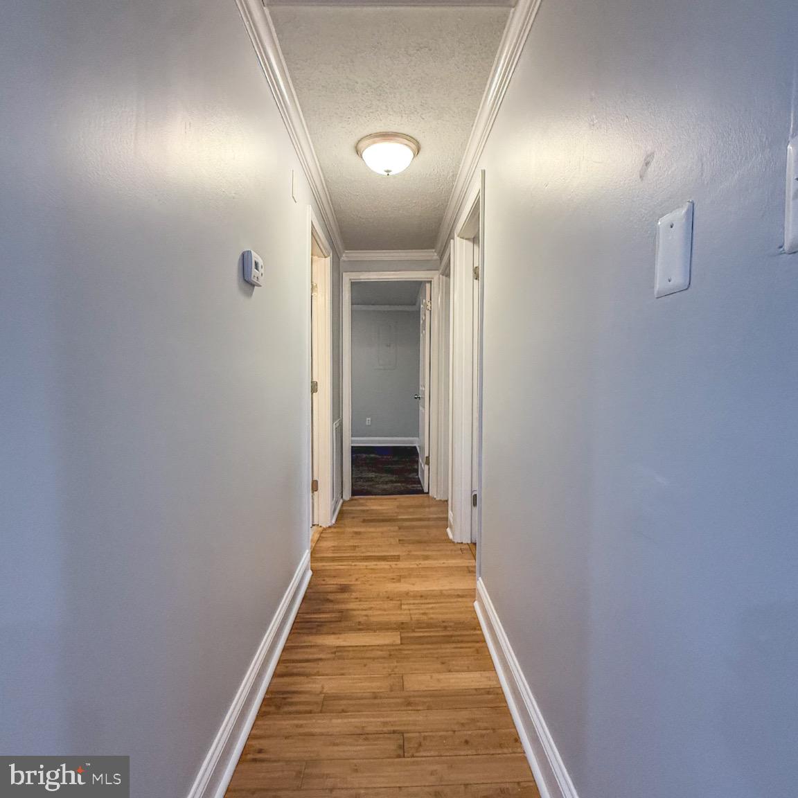 205 Biddle Road Accokeek, MD 20607 - Photo 22 of 31 a view of a hallway with wooden floor