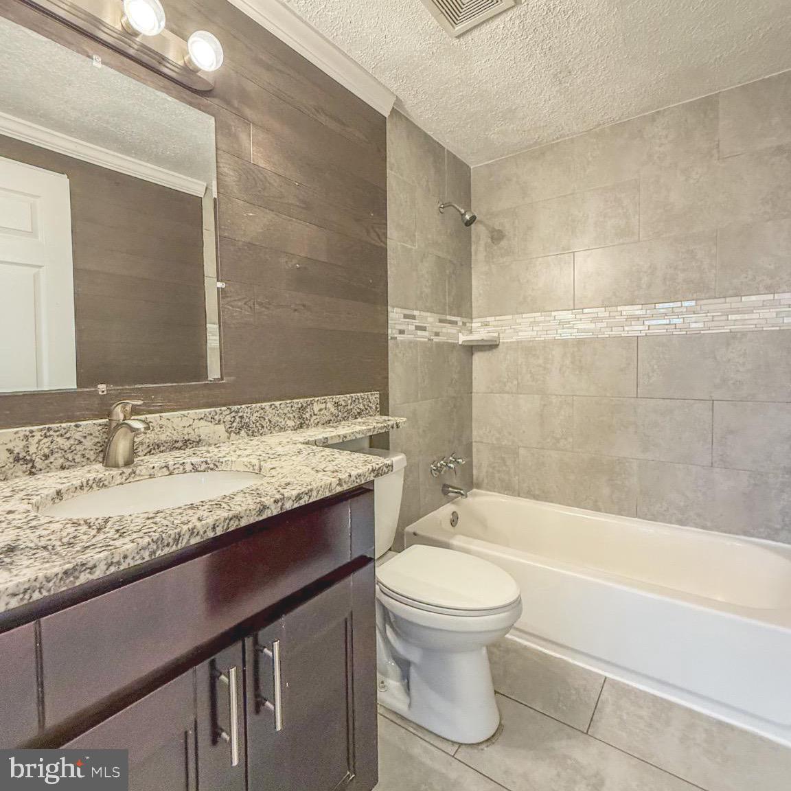205 Biddle Road Accokeek, MD 20607 - Photo 26 of 31 a bathroom with a granite countertop sink a toilet and bathtub