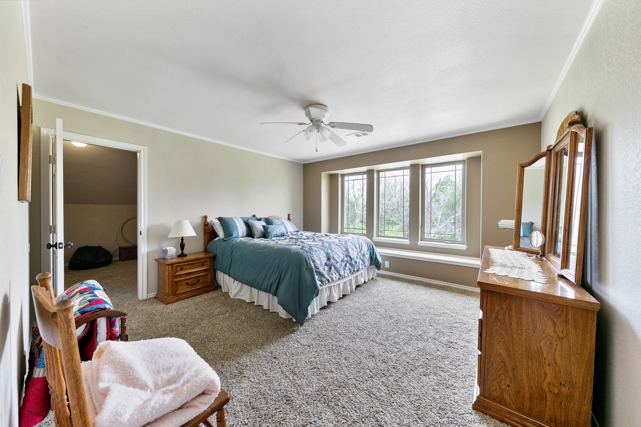 923 Y U Jones Road Richmond, TX 77469 - Photo 28 of 50 a spacious bedroom with a bed and glass walk in closet