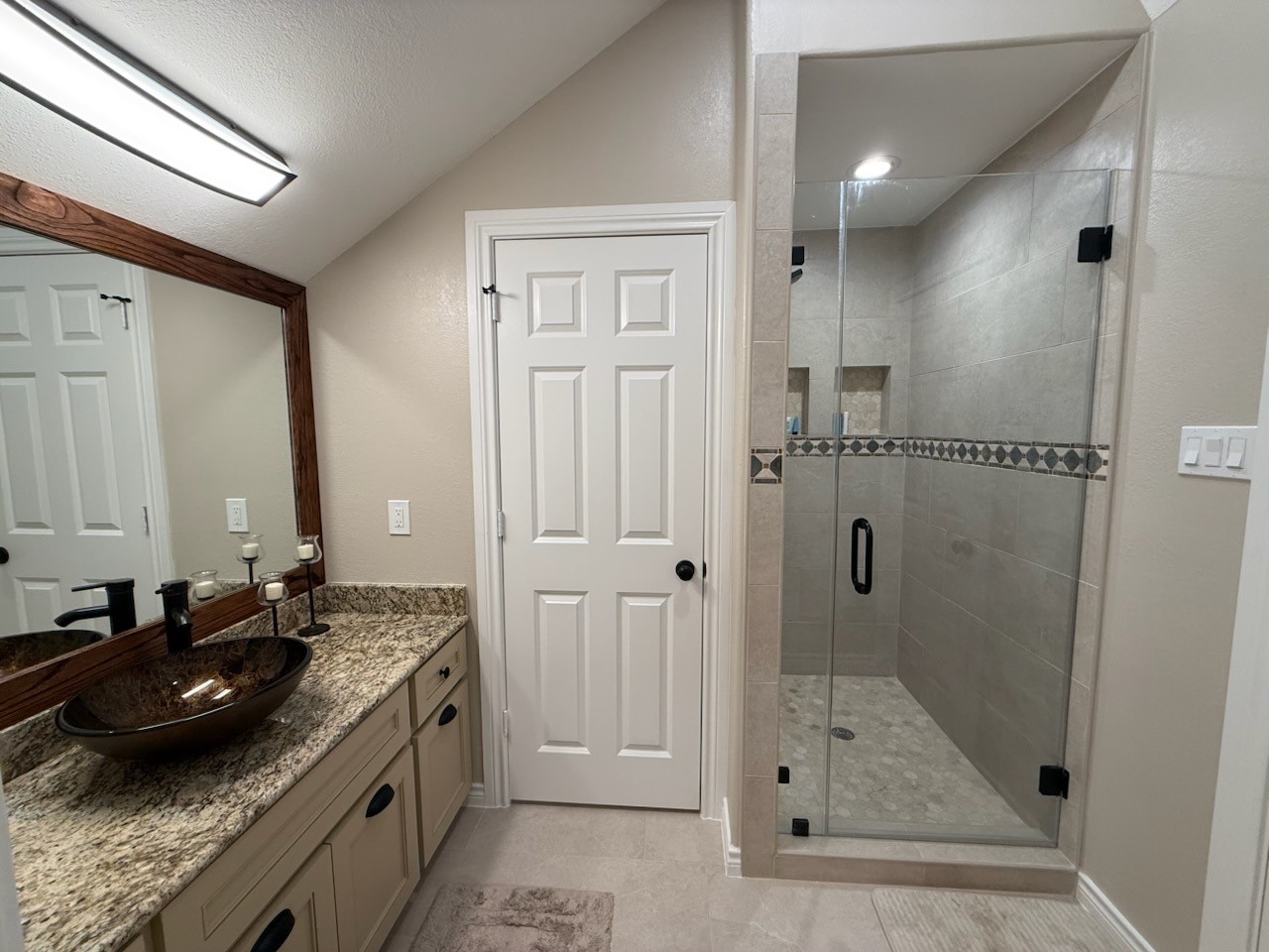 923 Y U Jones Road Richmond, TX 77469 - Photo 29 of 50 a bathroom with a granite countertop sink a mirror and shower
