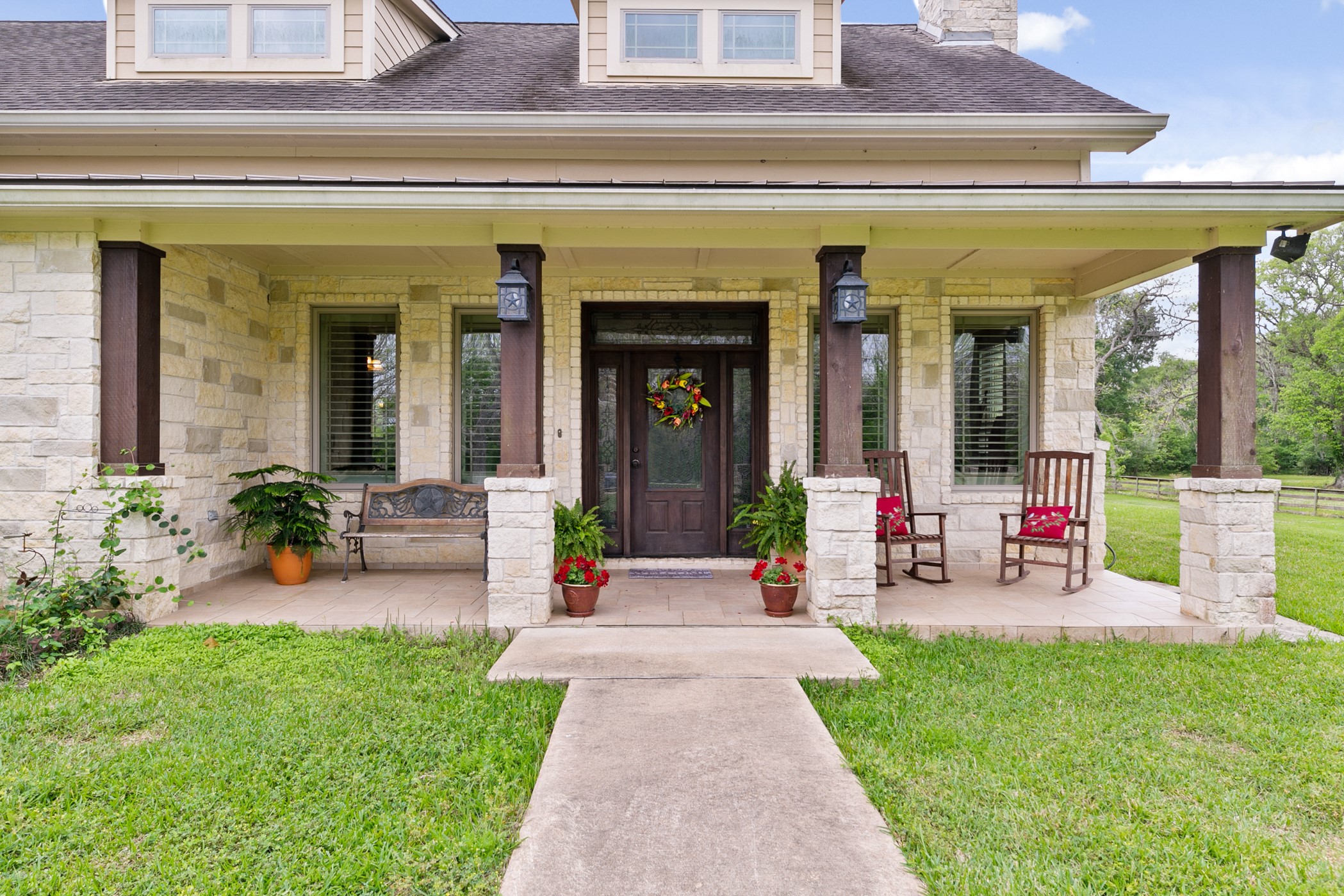 923 Y U Jones Road Richmond, TX 77469 - Photo 3 of 50 front view of a building with potted plants and a bench