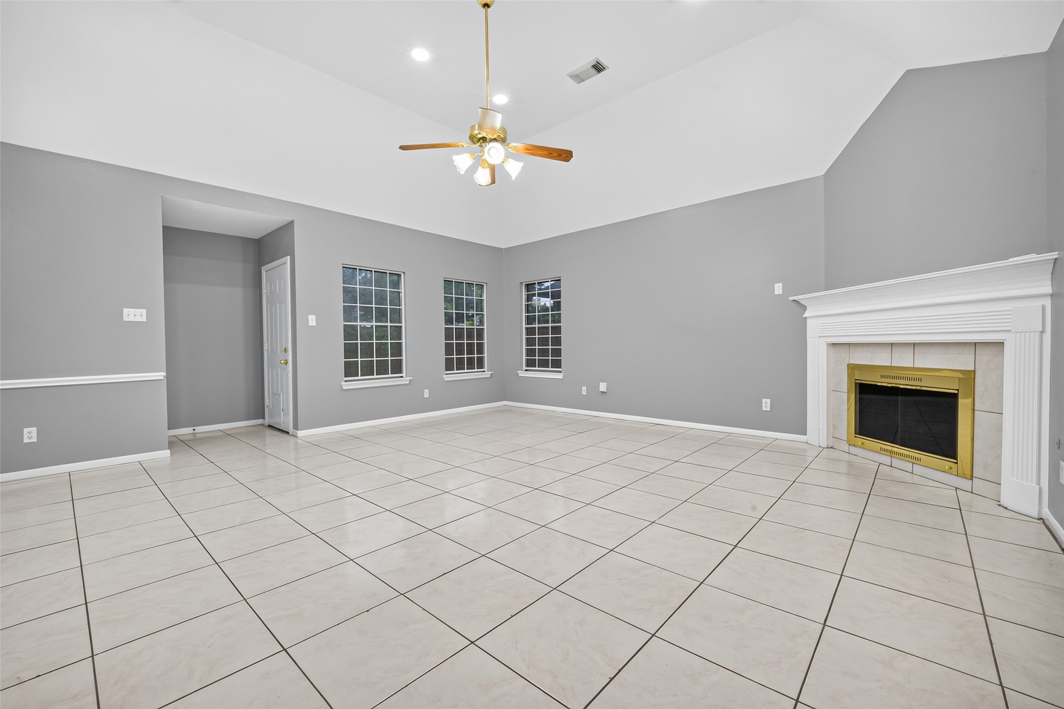 13607 Sable Lane Houston, TX 77014 - Photo 10 of 46 a view of an empty room with chandelier fan and fire place