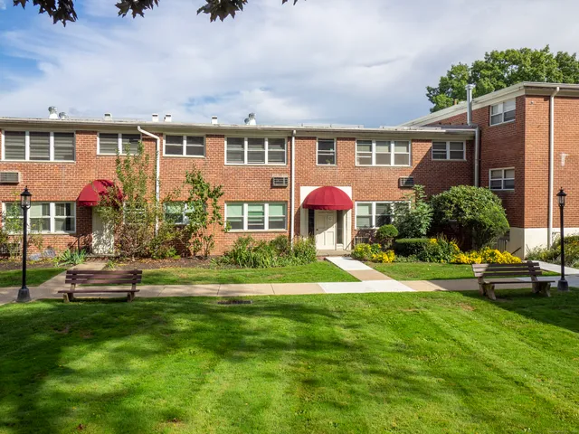 a front view of a house with a yard table and chairs