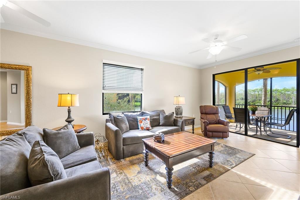 9727 Acqua Court, Unit 421 Naples, FL 34113 - Photo 1 of 35 a living room with furniture a rug and a large window