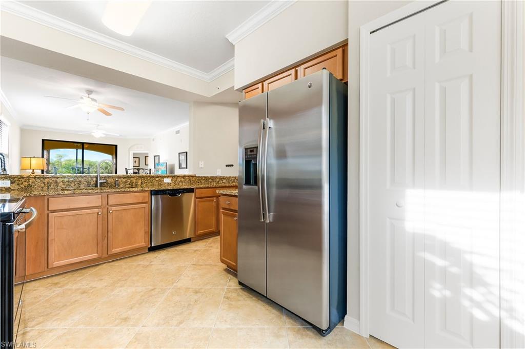 9727 Acqua Court, Unit 421 Naples, FL 34113 - Photo 11 of 35 a kitchen with a refrigerator sink and cabinets