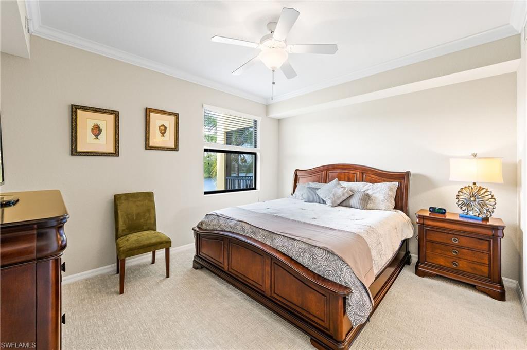 9727 Acqua Court, Unit 421 Naples, FL 34113 - Photo 13 of 35 a bedroom with a bed and a couch