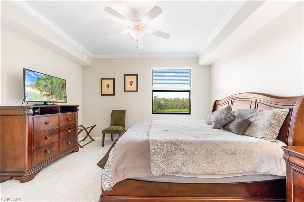 9727 Acqua Court, Unit 421 Naples, FL 34113 - Photo 14 of 35 a bedroom with a bed and wooden floor
