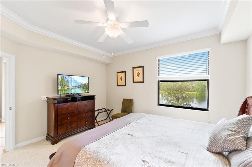 9727 Acqua Court, Unit 421 Naples, FL 34113 - Photo 15 of 35 a bedroom with a bed and a television