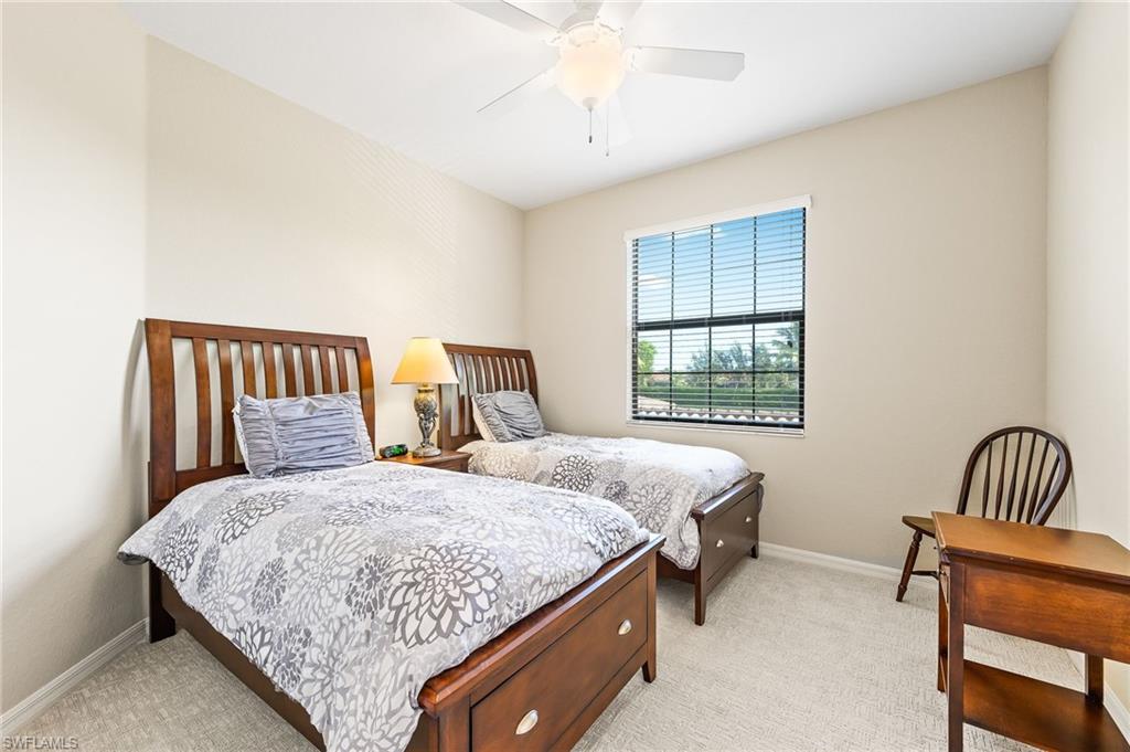 9727 Acqua Court, Unit 421 Naples, FL 34113 - Photo 19 of 35 a bedroom with a bed and window