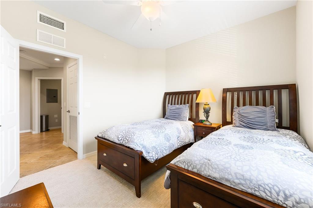 9727 Acqua Court, Unit 421 Naples, FL 34113 - Photo 20 of 35 a bedroom with two beds and painted walls