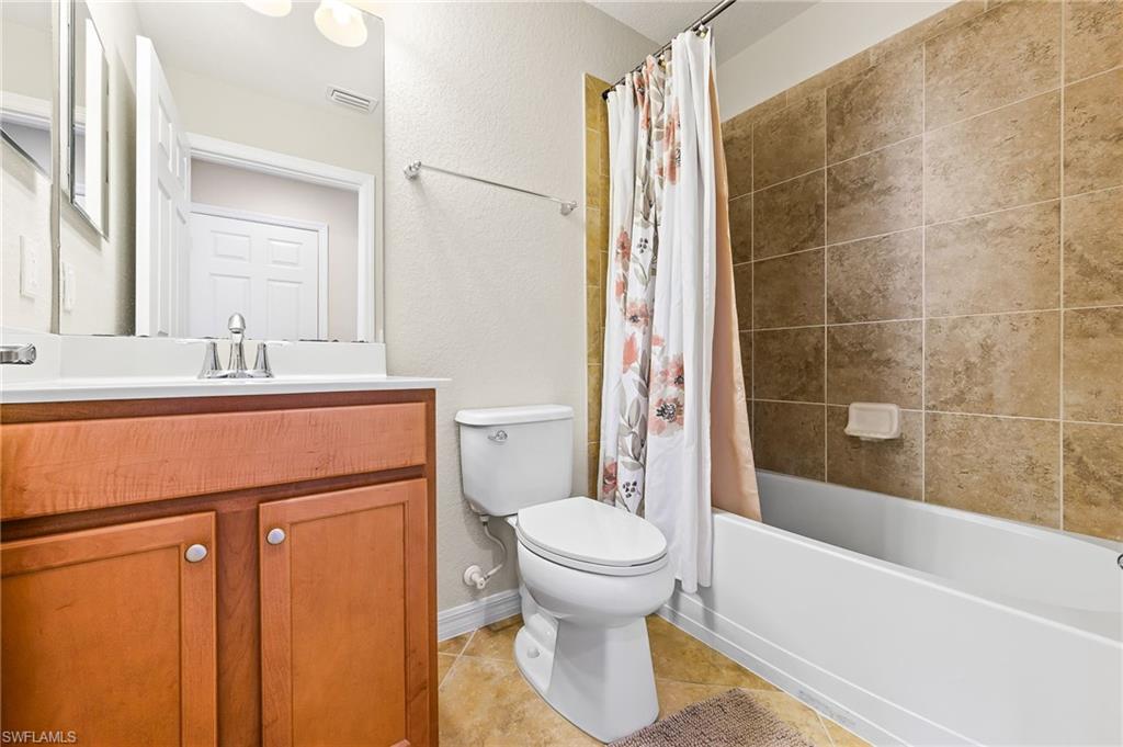 9727 Acqua Court, Unit 421 Naples, FL 34113 - Photo 21 of 35 a bathroom with a sink toilet and shower