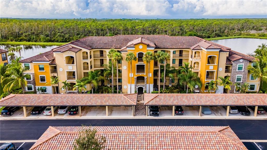 9727 Acqua Court, Unit 421 Naples, FL 34113 - Photo 27 of 35 a view of a large building with a outdoor space